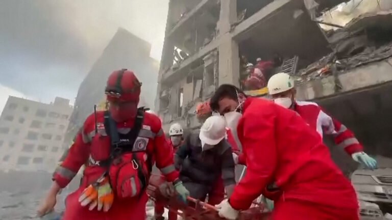 Rescue workers search rubble after strikes hit Tehran neighbourhood