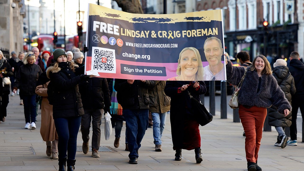 protesters-holding-a-sign-for-craig-and-lindsay-foreman.jpg