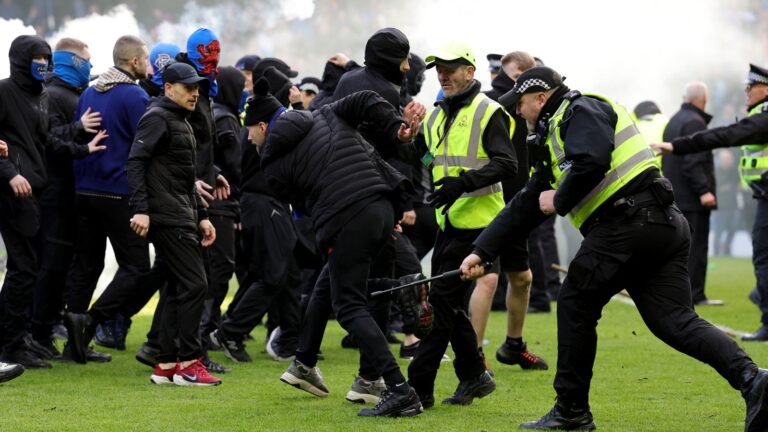 Rangers and Celtic fans clash on pitch after Scottish Cup tie | UK News