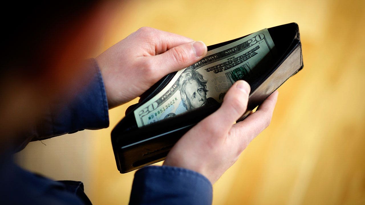 hands-in-wallet-dollars-getty.jpg
